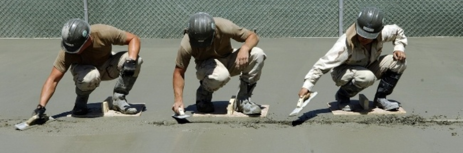 three workers using concrete