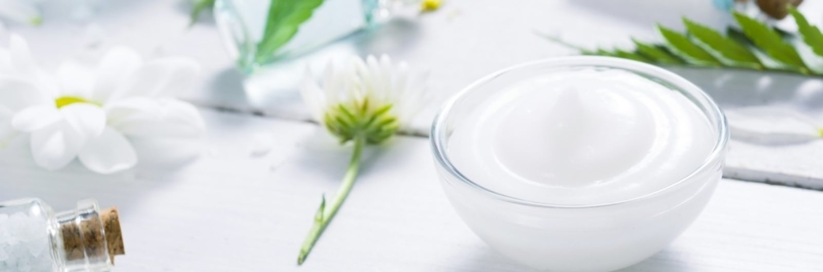 cup with gel and flowers around