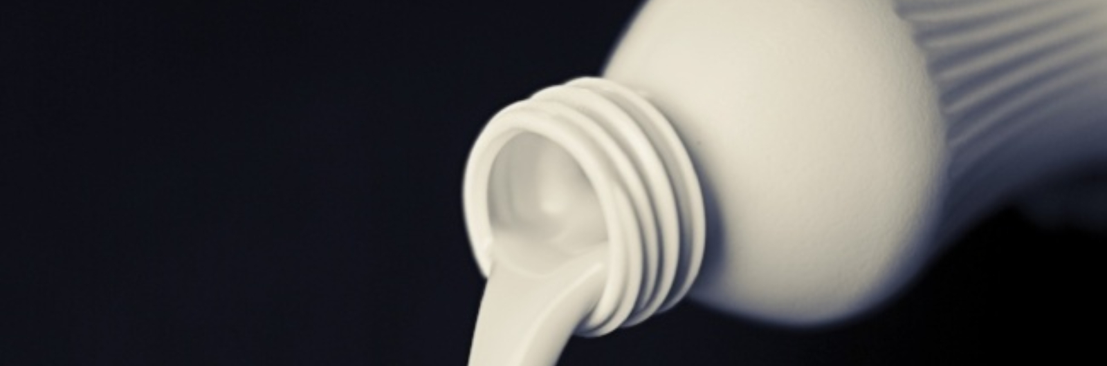 white liquid flowing out from a bottle