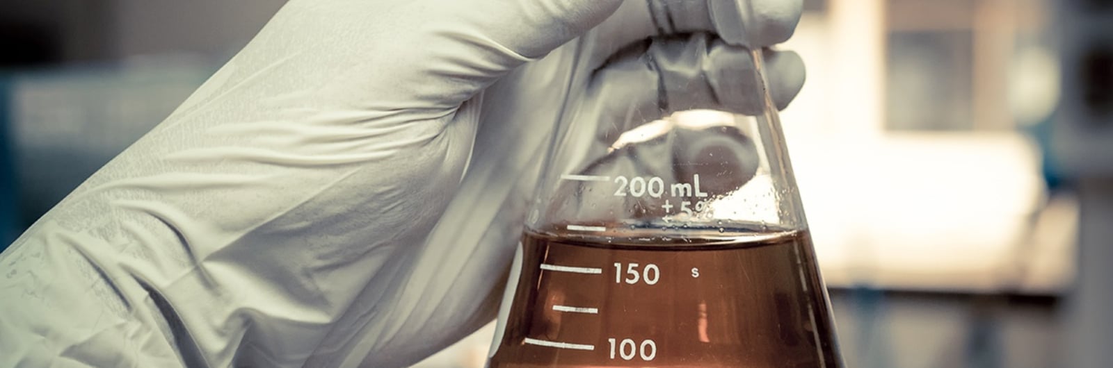 hand holding a measurement glass